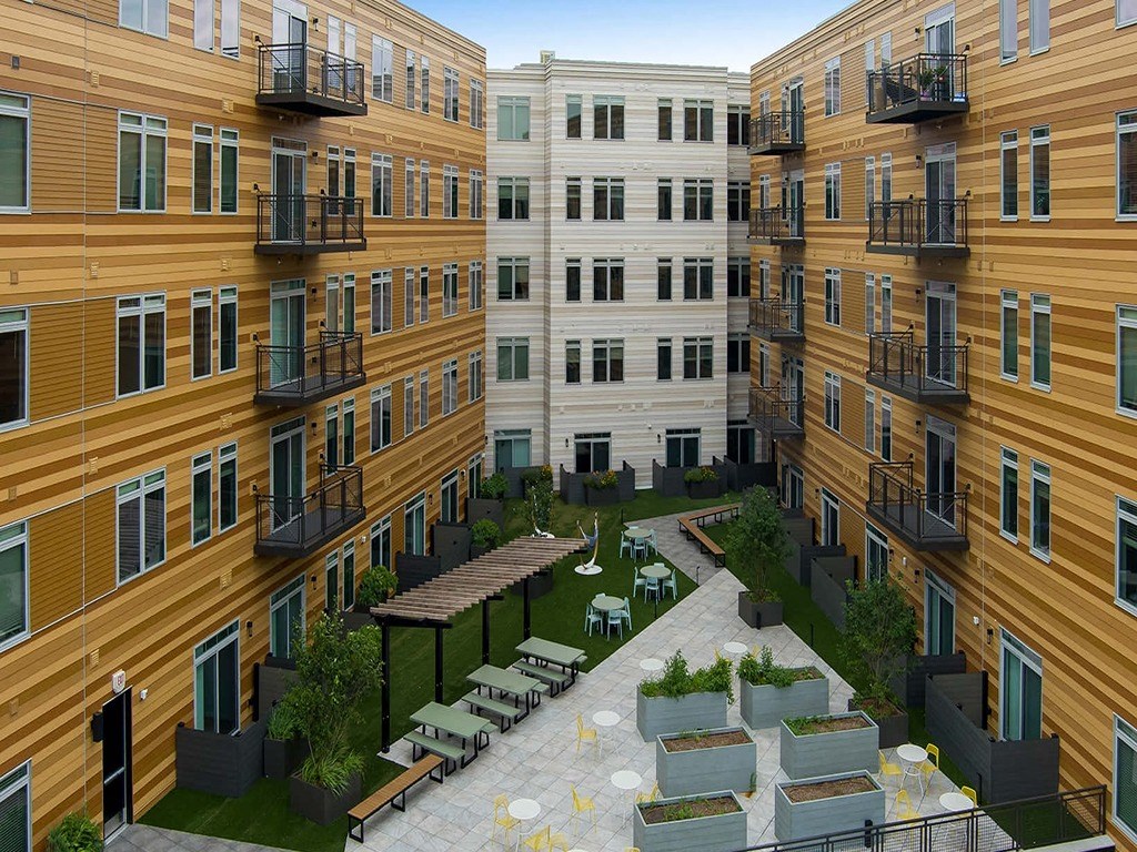 a rendering of an apartment building with a courtyard